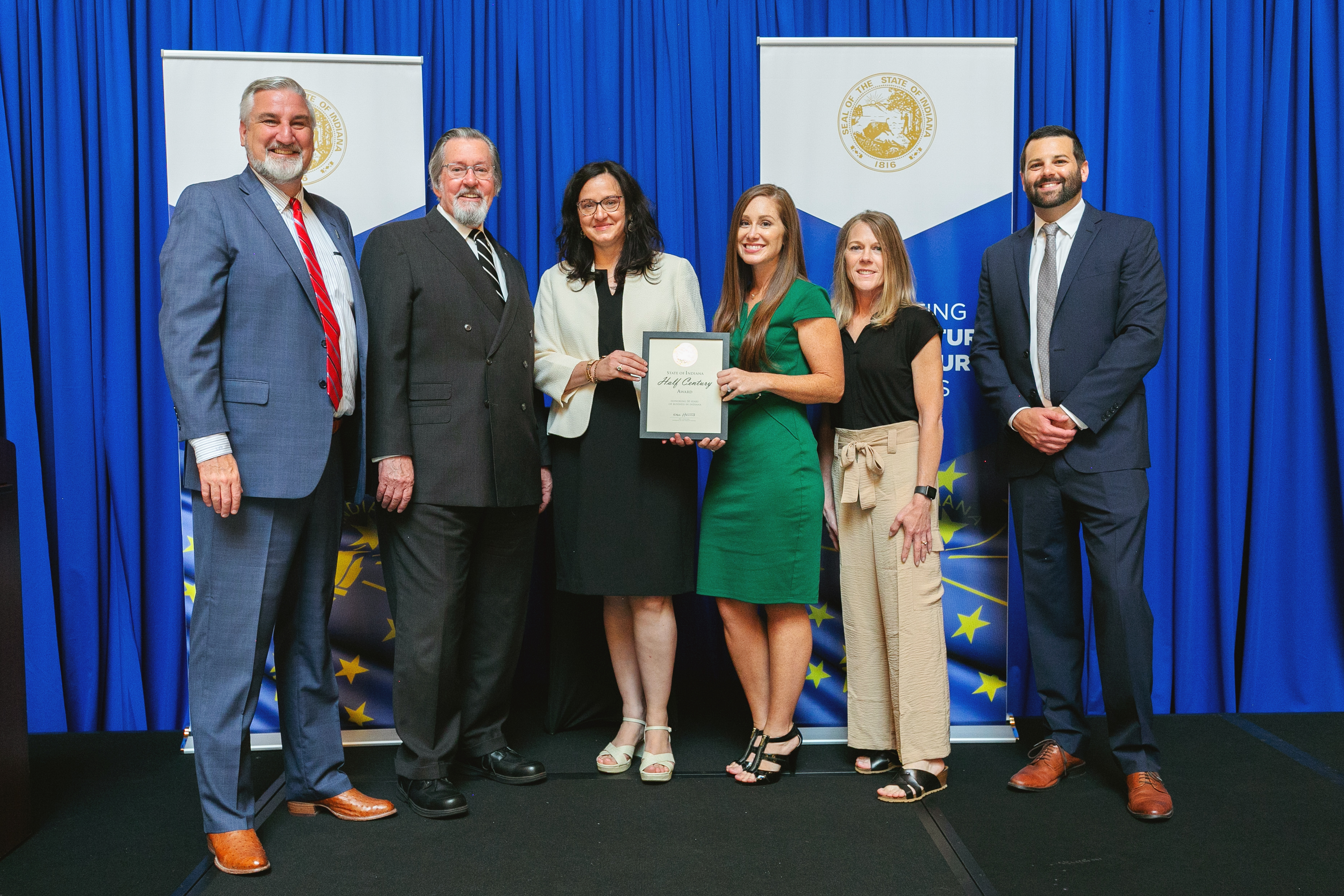 Rice & Rice Attorneys Recognized for 50 Years (L-R) Governor Eric Holcomb, Attorney Cliff Rice, Ami Rice, Gabrielle Tyler, Tracy Healy and Secretary of Commerce, David Rosenberg Valparaiso, Indiana